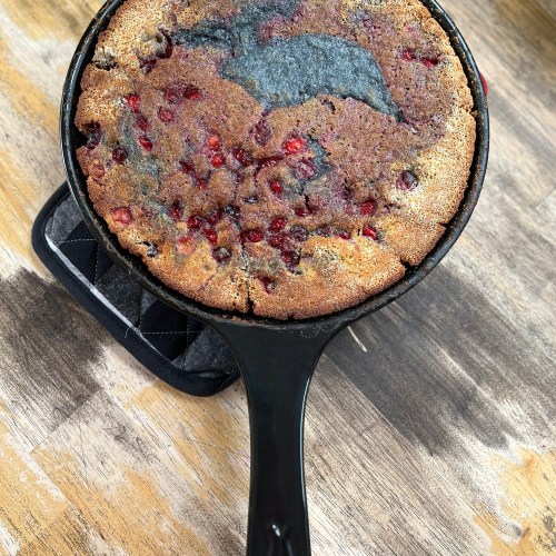 Cherry Cranberry Cobbler in an Xtrema skillet on a hot pad on a wood table