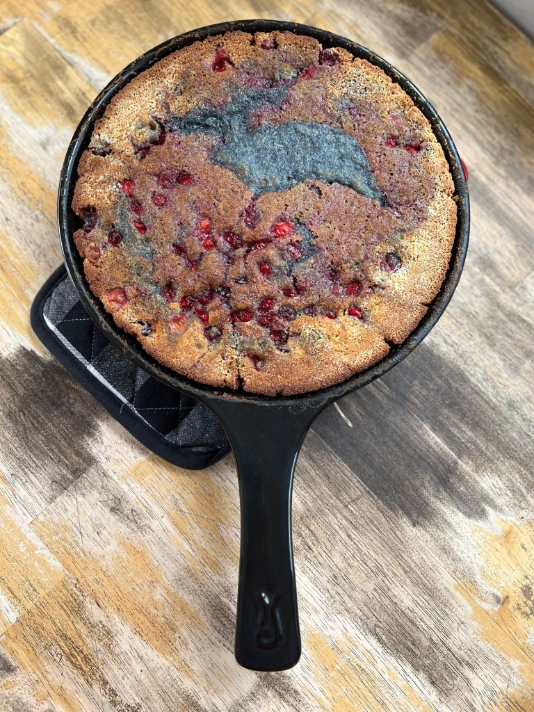 Cherry Cranberry Cobbler in an Xtrema skillet on a hot pad on a wood table