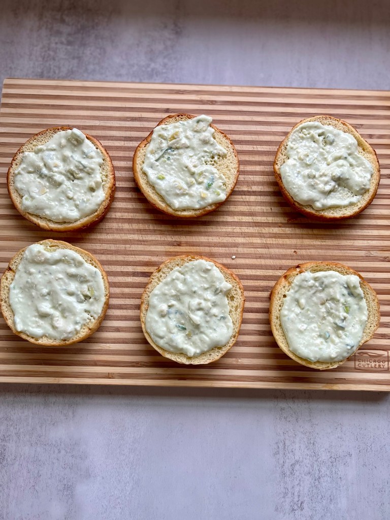 Brioche buns with avocado blue cheese dressing smeared on them