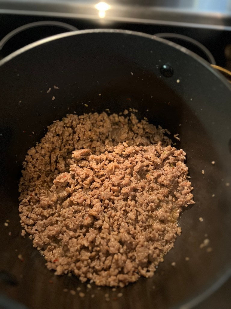 Browned italian sausage in a stock pot