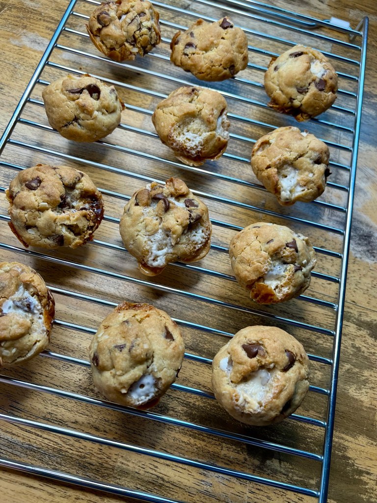 Chocolate Chip Coconut Marshmallow Cookies on a cooling rack on a wooden table