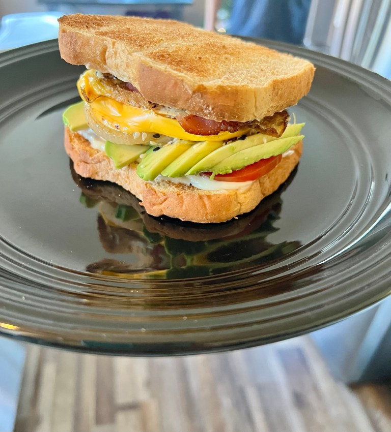 Ultimate breakfast sandwich on a black plate