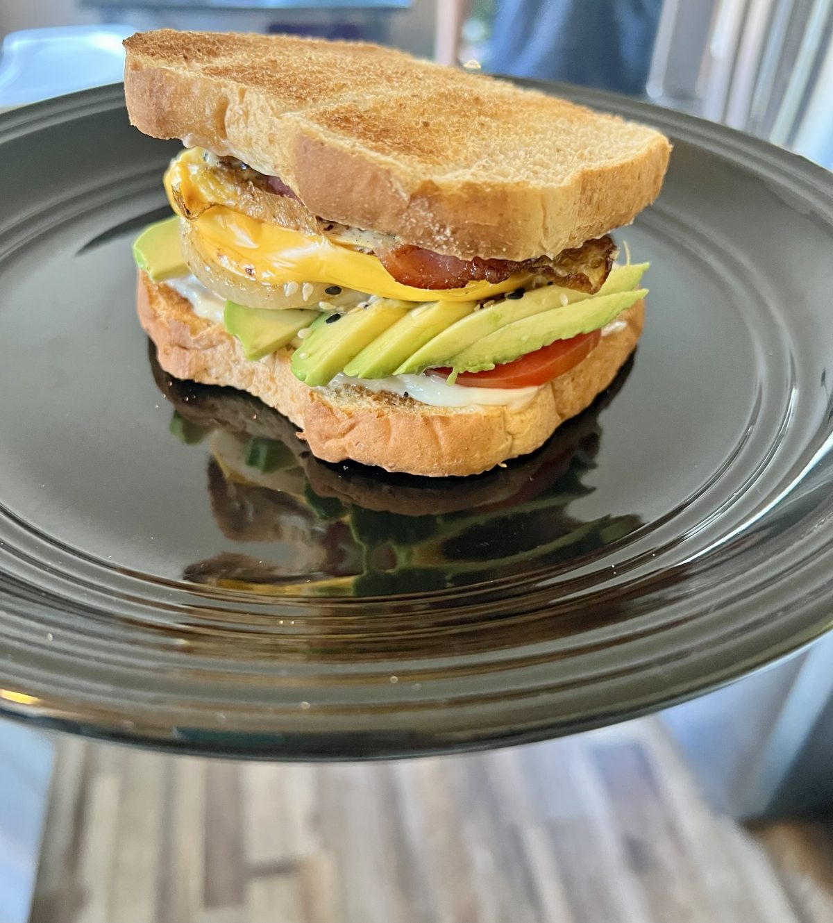 Ultimate breakfast sandwich on a black plate