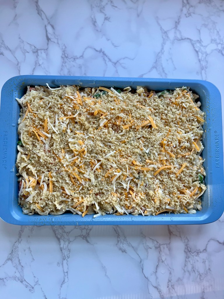 Chicken noodle casserole in a blue pan right before going into the oven