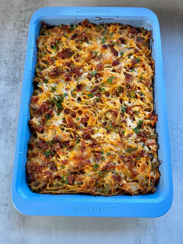 Freshly baked chicken spaghetti in a blue farberware pan