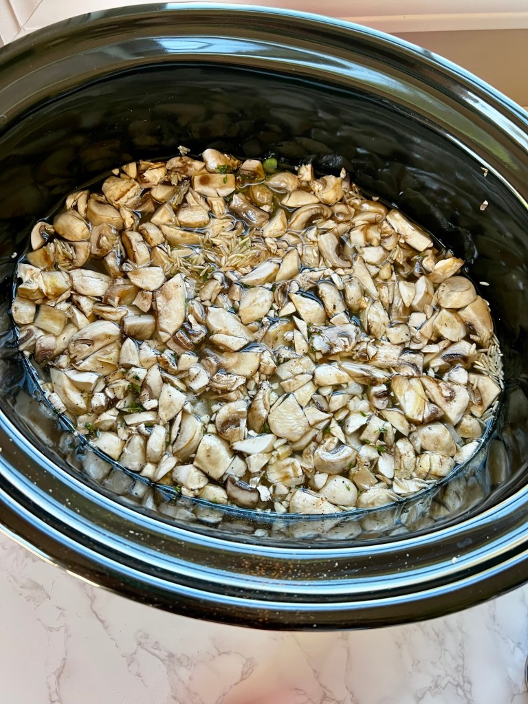 Creamy chicken and rice soup in the crockpot just before getting cooked