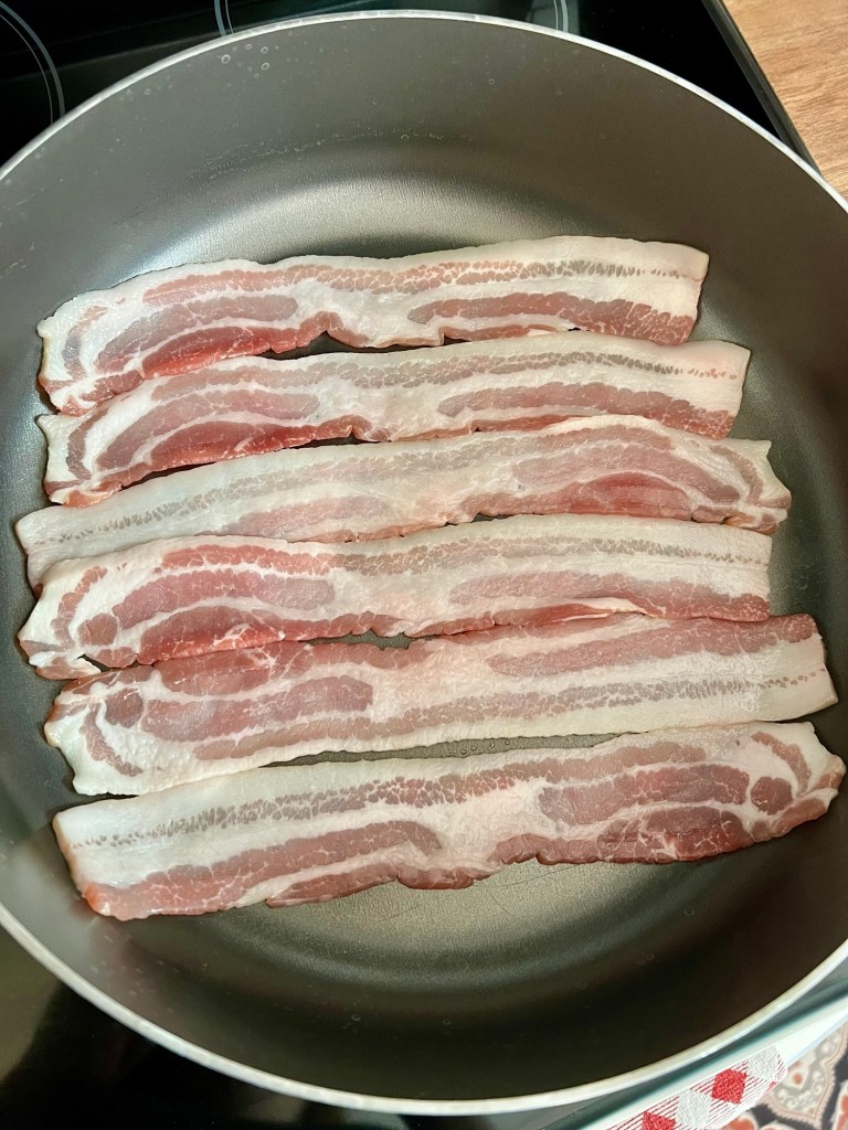 Bacon in a pan on the stove