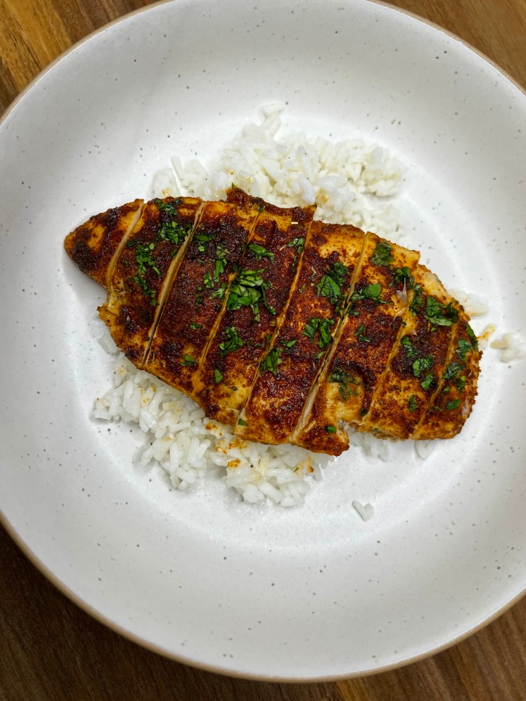 Cilantro Lime Chicken on a bed of rice on a white plate