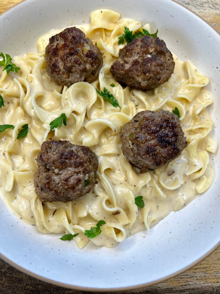 Swedish Meatballs in a white bowl on a wooden counter