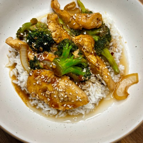 Chinese Chicken and Broccoli over some rice in a white bowl