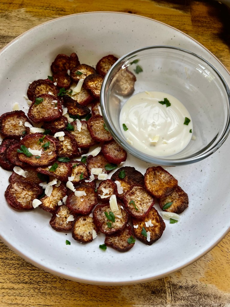Air Fried Radish Chips in a white bowl with some ranch and parsley and parm for garnish