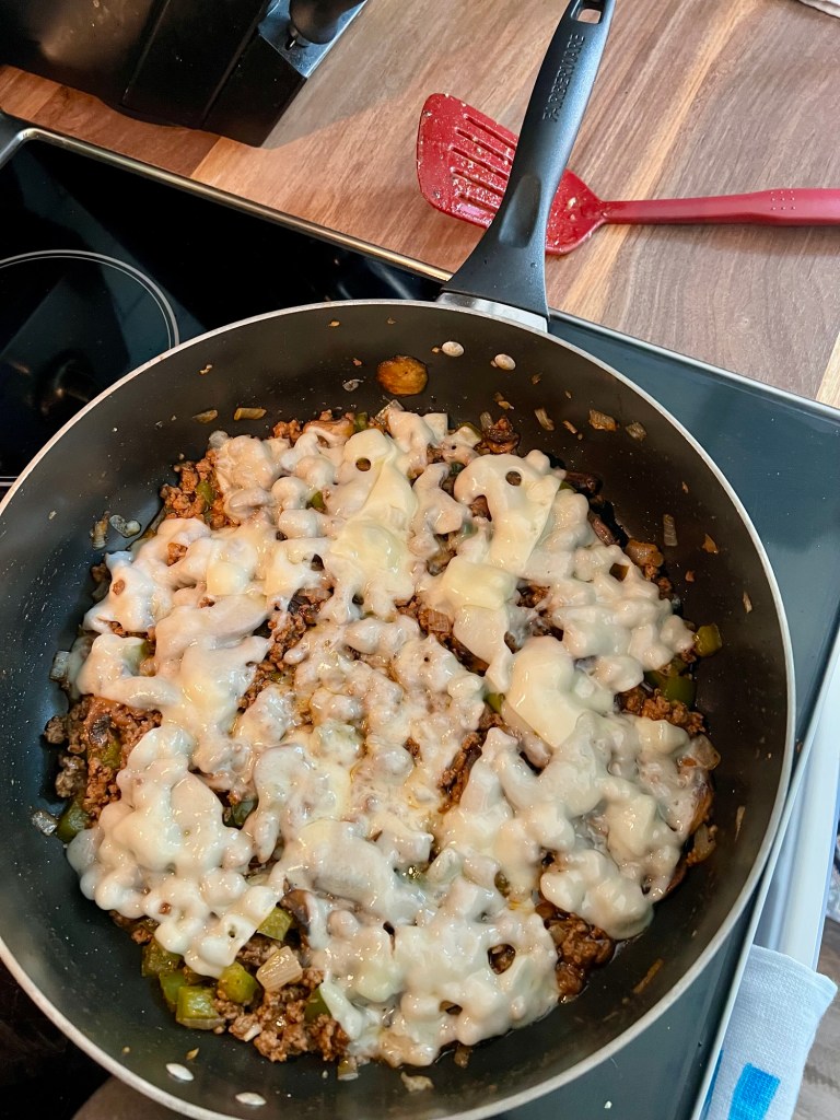 Mushroom swiss sloppy joe mix in a skillet on the stove