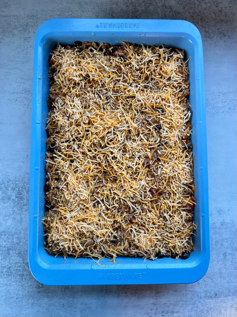 Burrito bake in a blue baking pan before going into the oven
