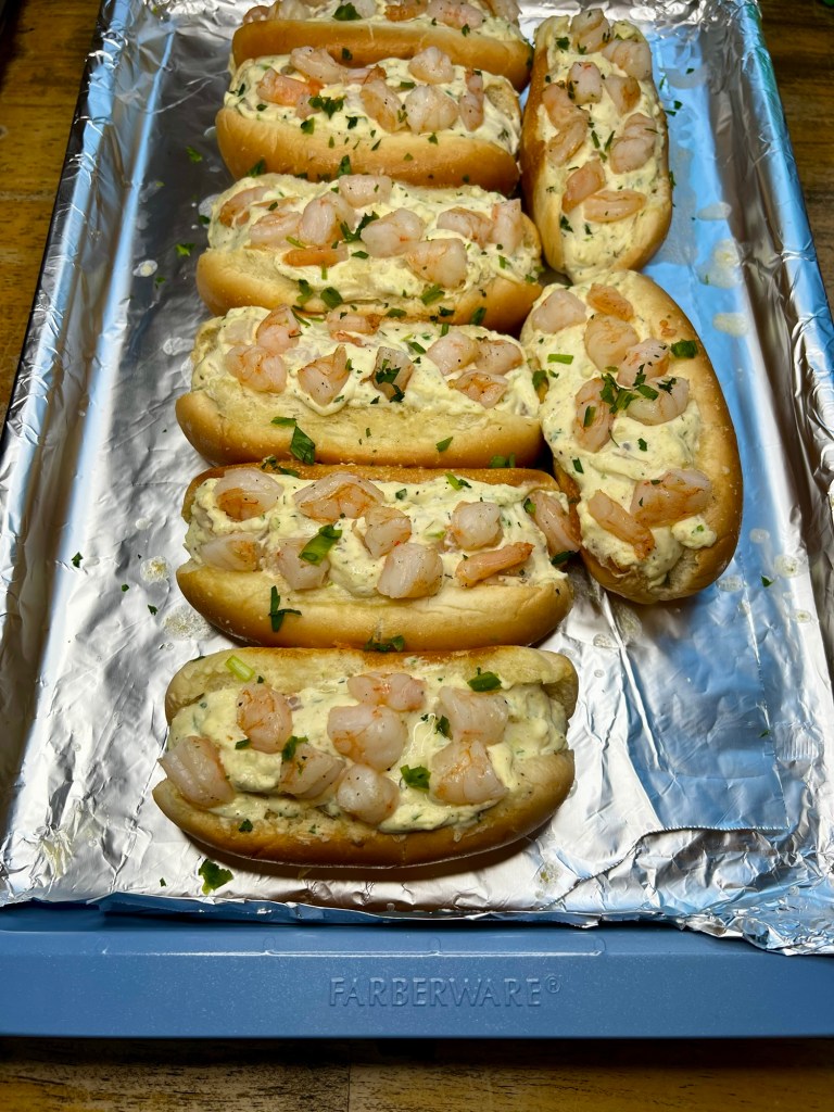 Shrimp rolls on a blue baking sheet after being baked