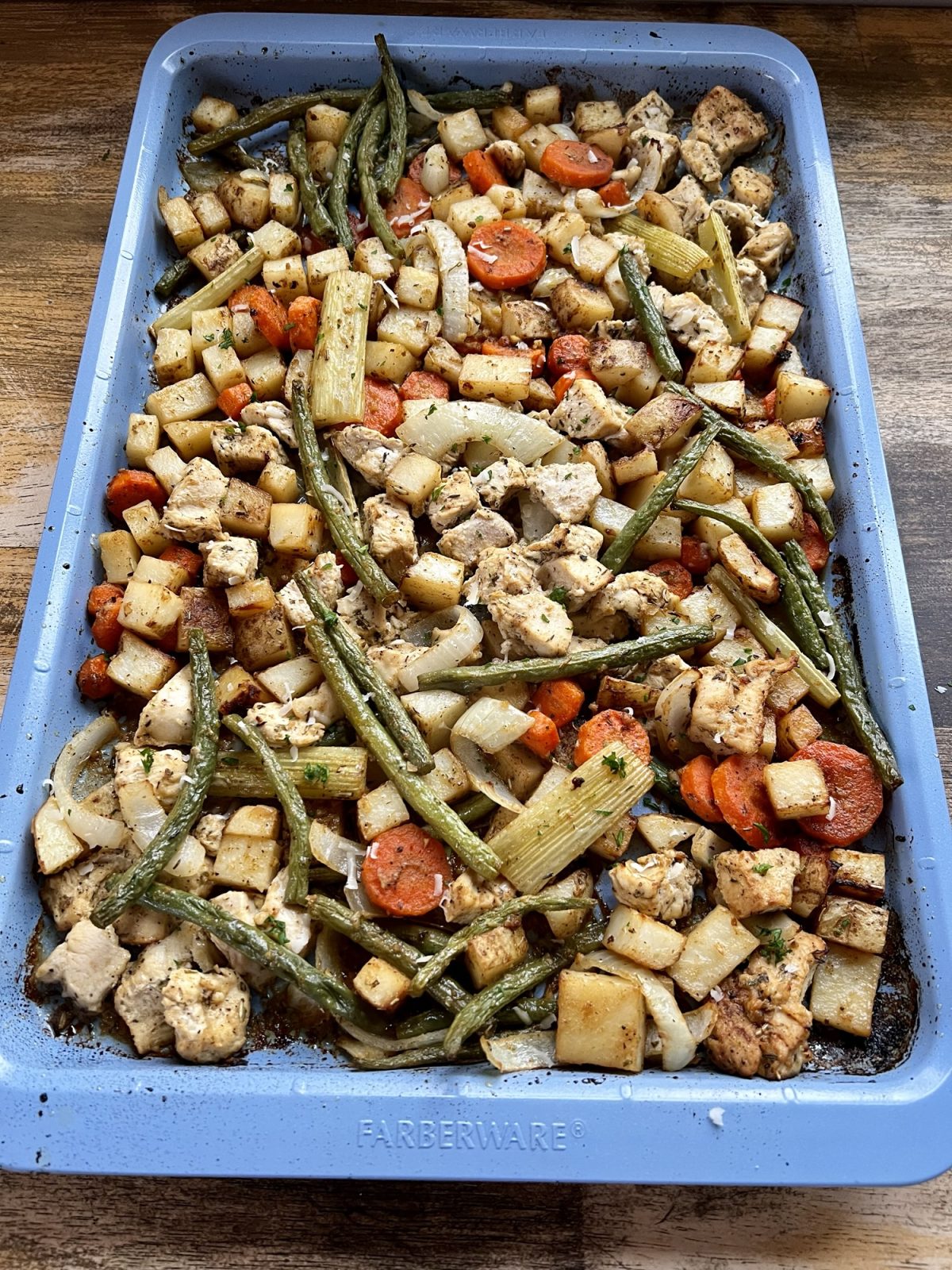 Harvest sheet pan dinner on a blue baking sheet after being baked