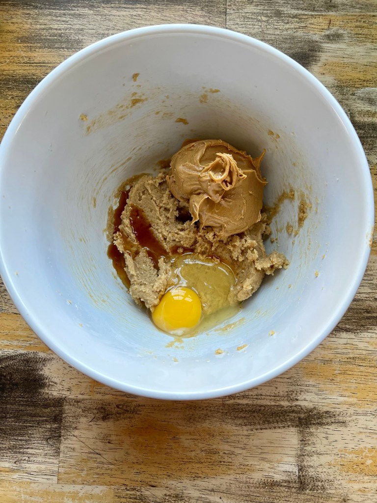 Wet ingredients for cookies in a mixing bowl before being beaten