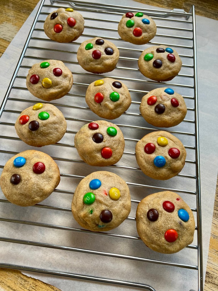 Peanut Butter M&M cookies on a cookie rack over some parchment paper