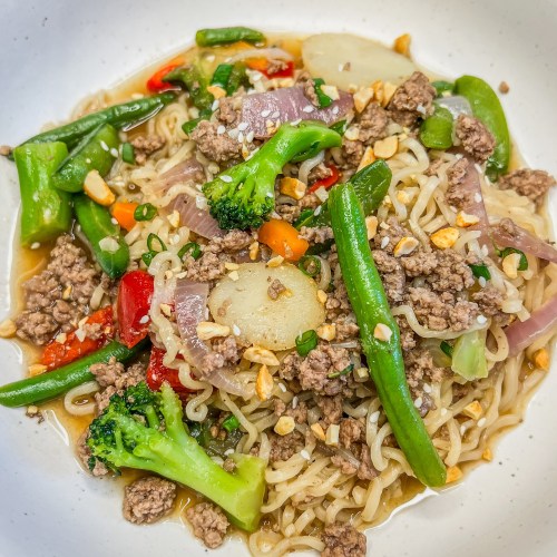 Beef Ramen in a big white bowl on a wooden countertop