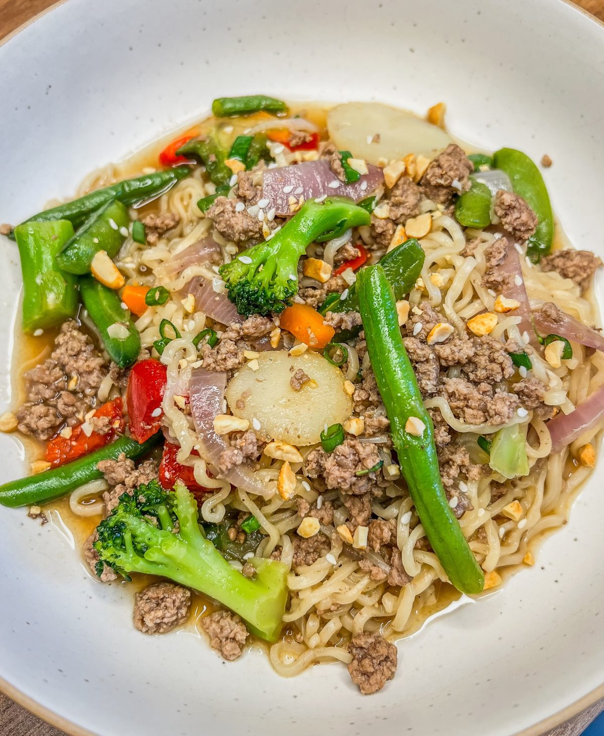 Beef Ramen in a big white bowl on a wooden countertop