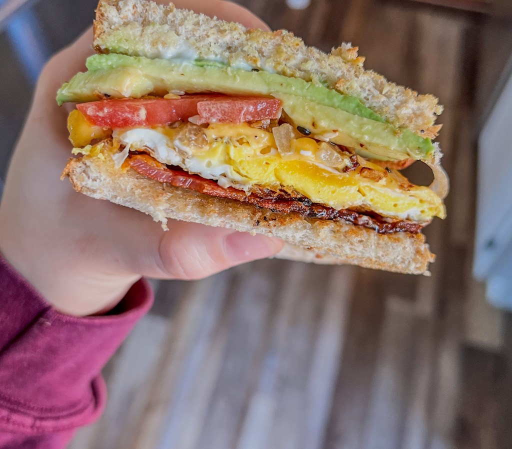 Ultimate breakfast sandwich that's been sliced in half to show the inside