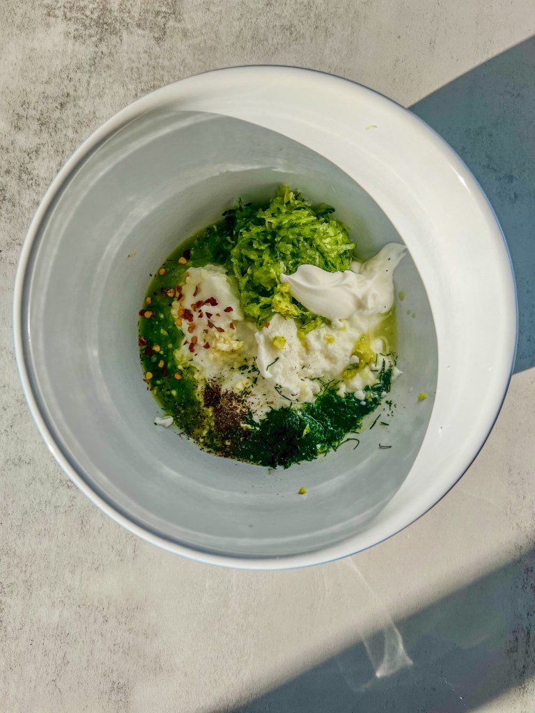 Ingredients for homemade tzatziki in a mixing bowl