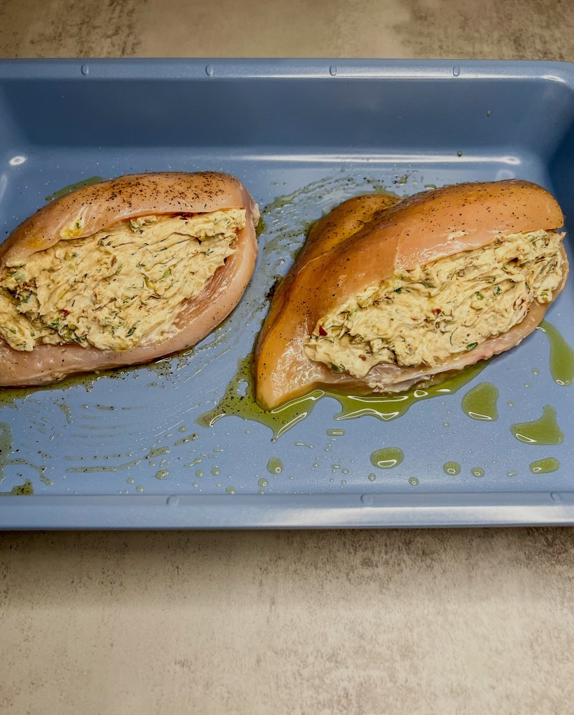 Chicken breasts that have been stuffed with a cream cheese, herb, and veggie mixture