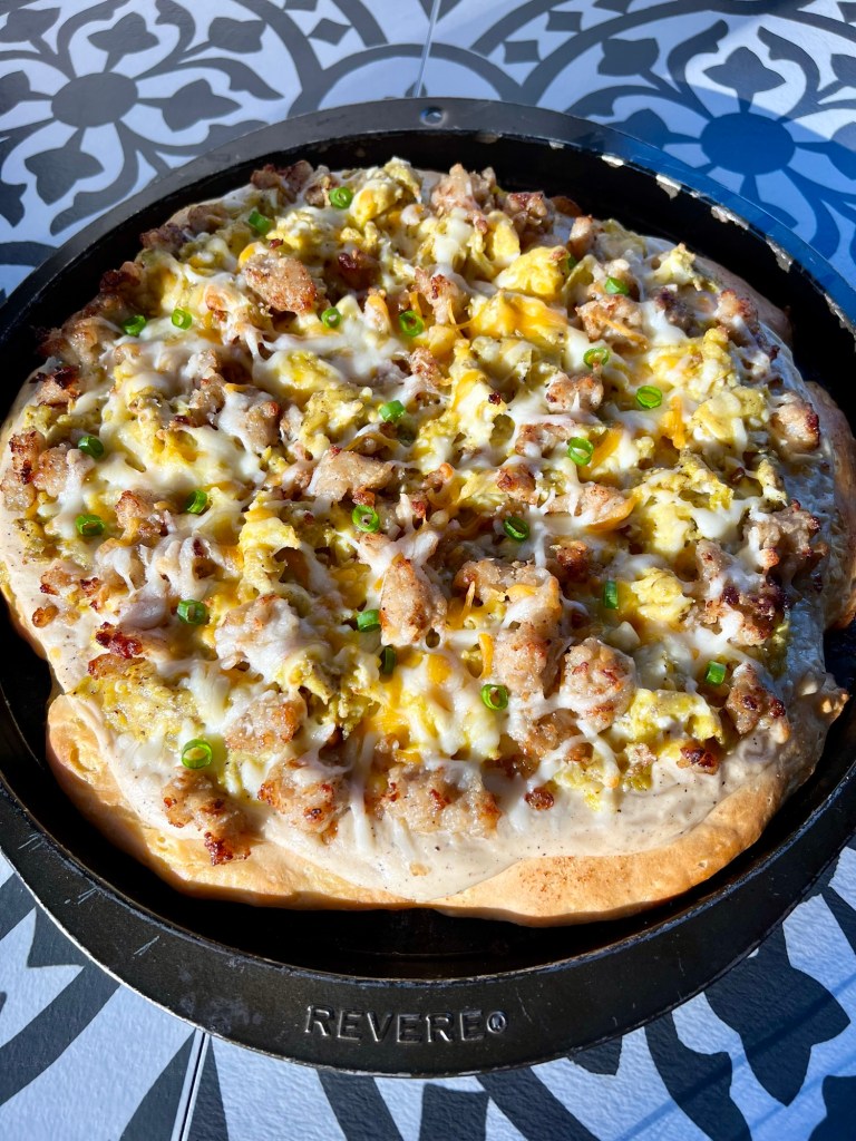 Biscuits and gravy breakfast pizza in a pan on a countertop
