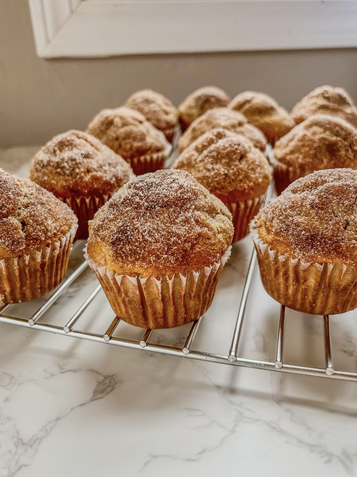 Carrot Crumble Muffins fresh out of the oven on a cooling rack