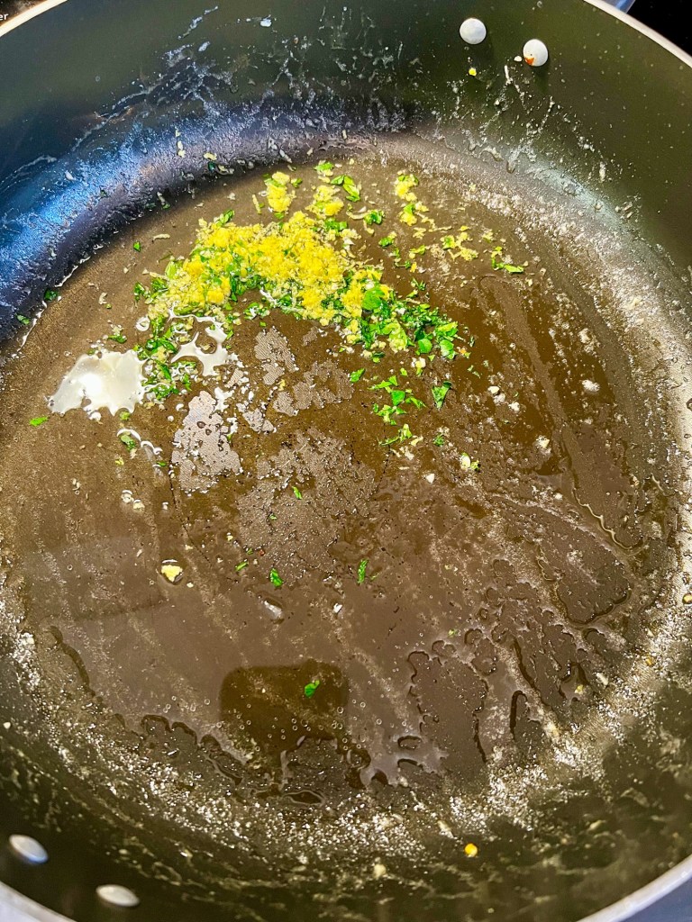 Scampi sauce being made in a skillet on the stove