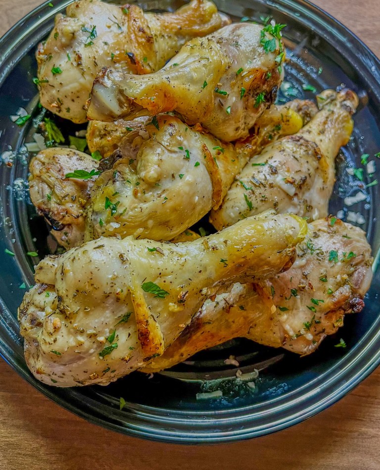 Lemon Herb Chicken Drumsticks on a black plate