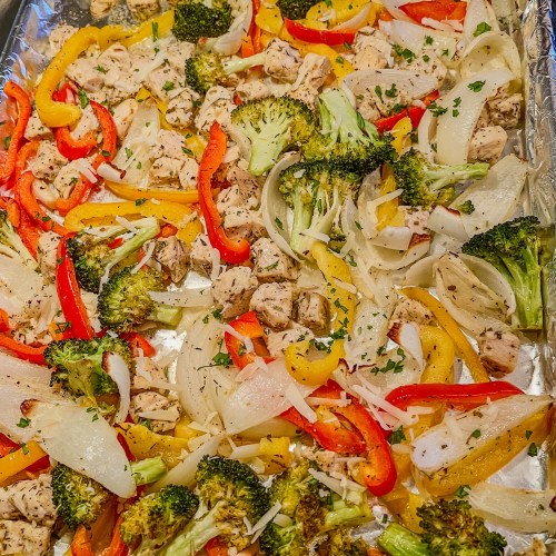 Chicken pepper sheet pan on the stove top after just coming out of the oven