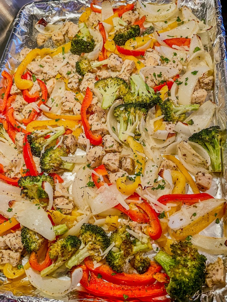Chicken pepper sheet pan on the stove top after just coming out of the oven