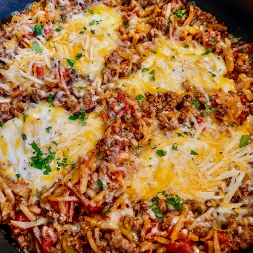 Cheesy beefy breakfast skillet in a large skillet on the stove