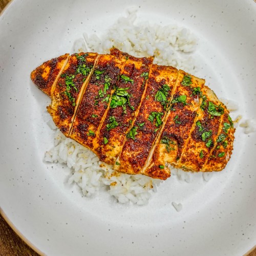 Cilantro Lime Chicken on a bed of rice on a white plate