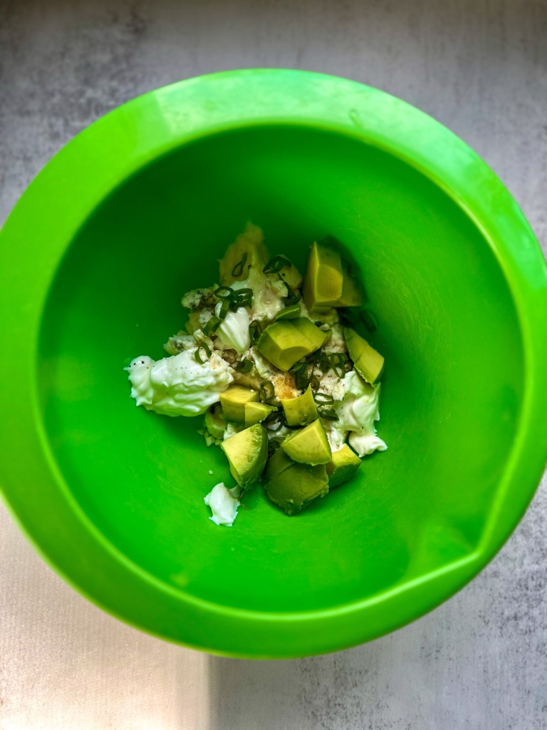 Ingredients for avocado blue cheese dressing in a bowl before being combined