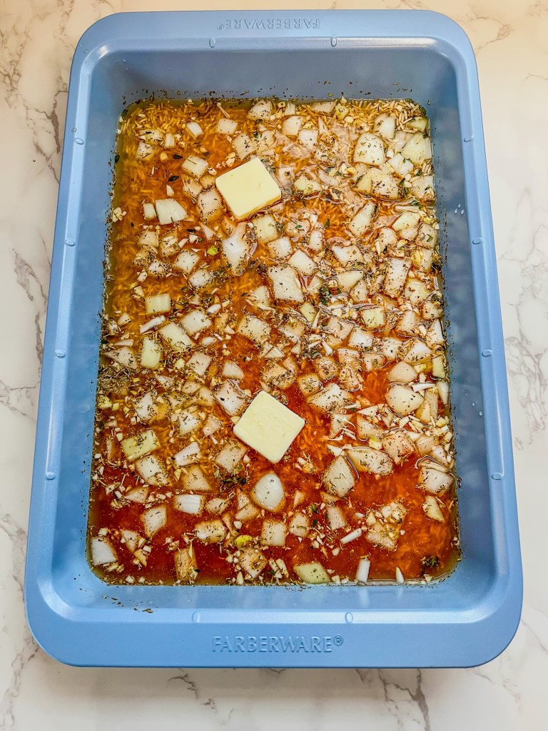A one pan chicken and rice dinner being prepped for baking