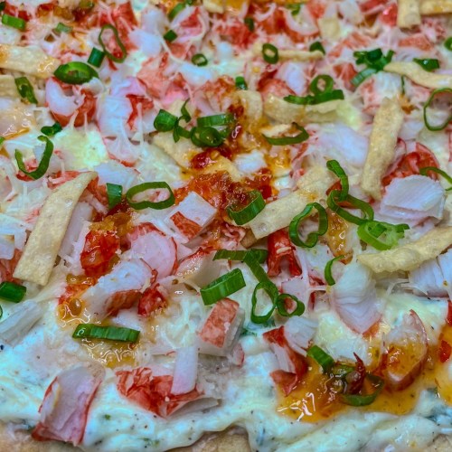Crab Rangoon Pizza with green onion and sweet chili sauce on top