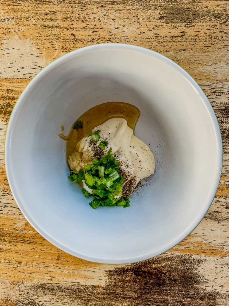 Ingredients for honey mustard mayo in a mixing bowl before being combined
