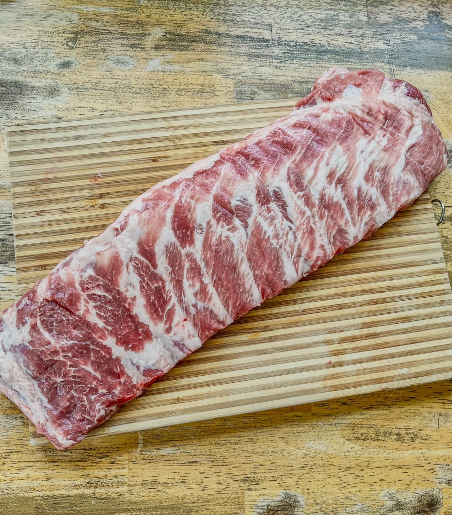 Raw St Louis Style Ribs getting prepped to make grilled bbq ribs