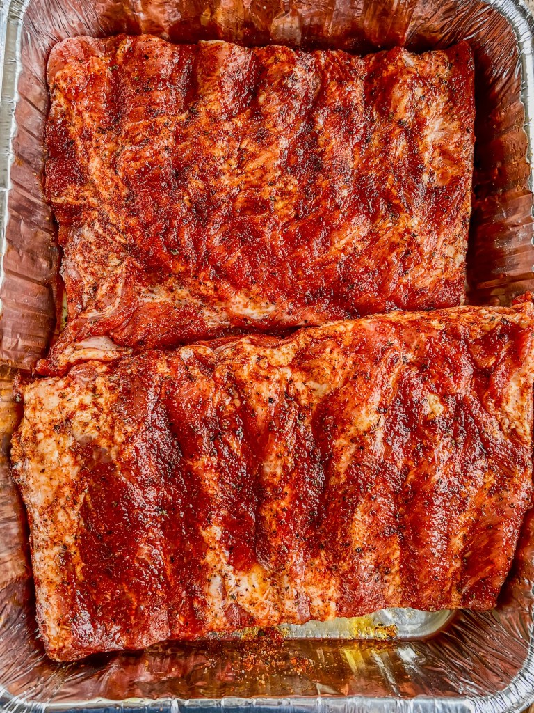 St Louis Style ribs with spices rubbed all over them, cut in half and put in an aluminum pan