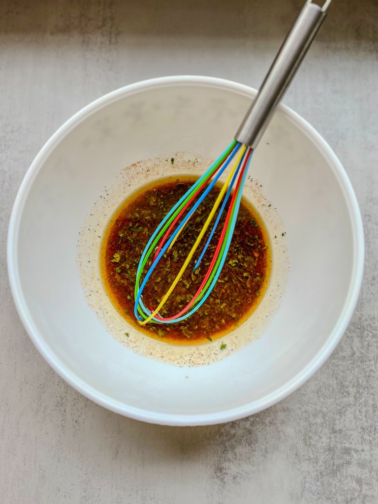 Hawaiian chicken marinade in a bowl with a whisk inside