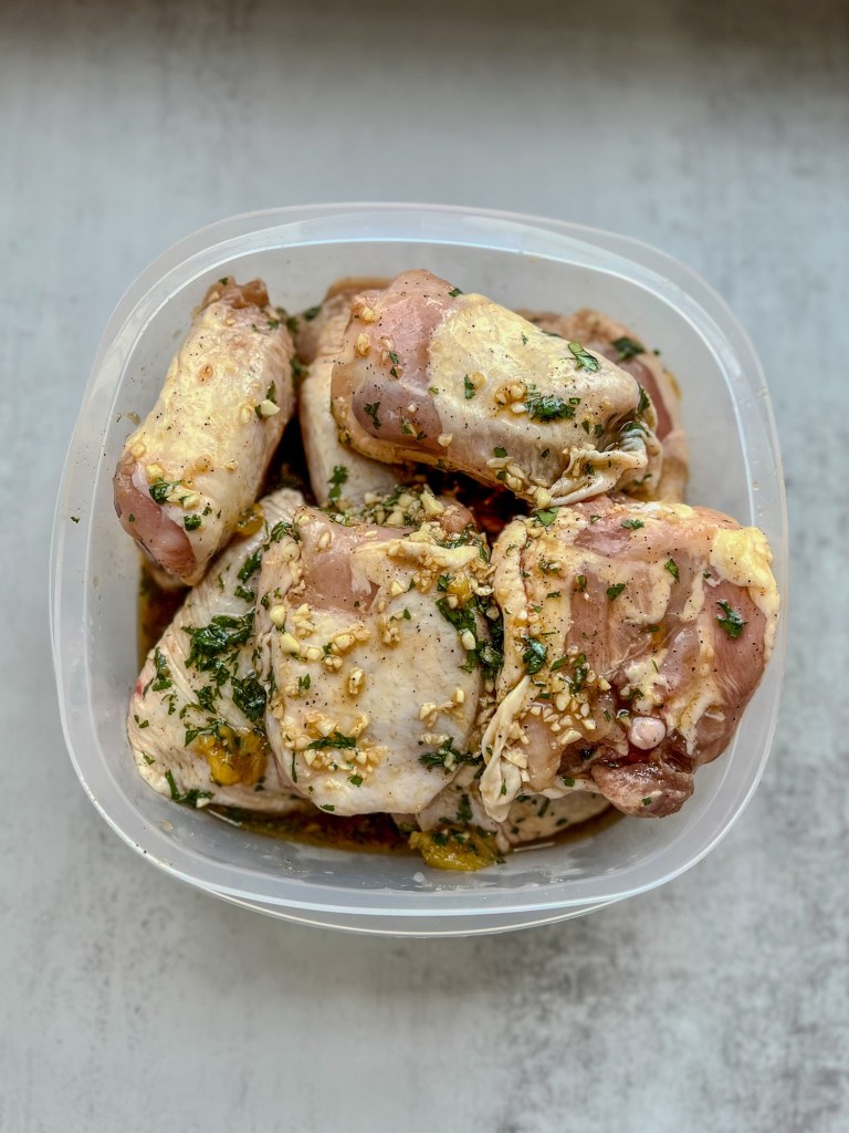 Chicken thighs in a Hawaiian marinade in a large Tupperware