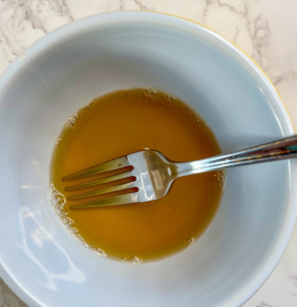 Honey water in a bowl with a fork inside