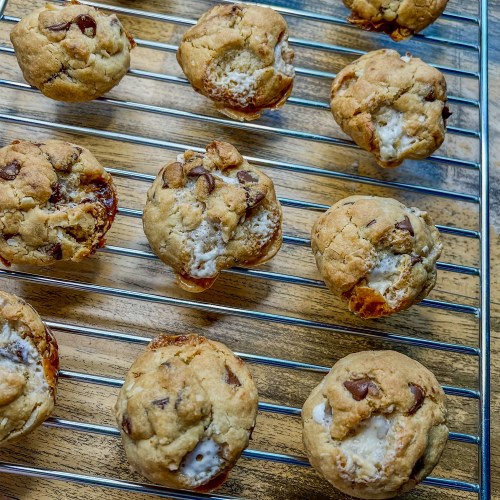 Chocolate Chip Coconut Marshmallow Cookies on a cooling rack on a wooden table