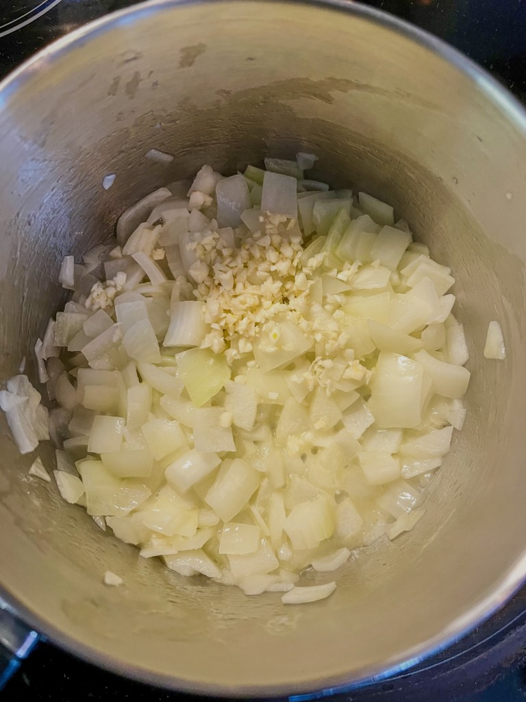Onions and garlic cooking in a saucepan