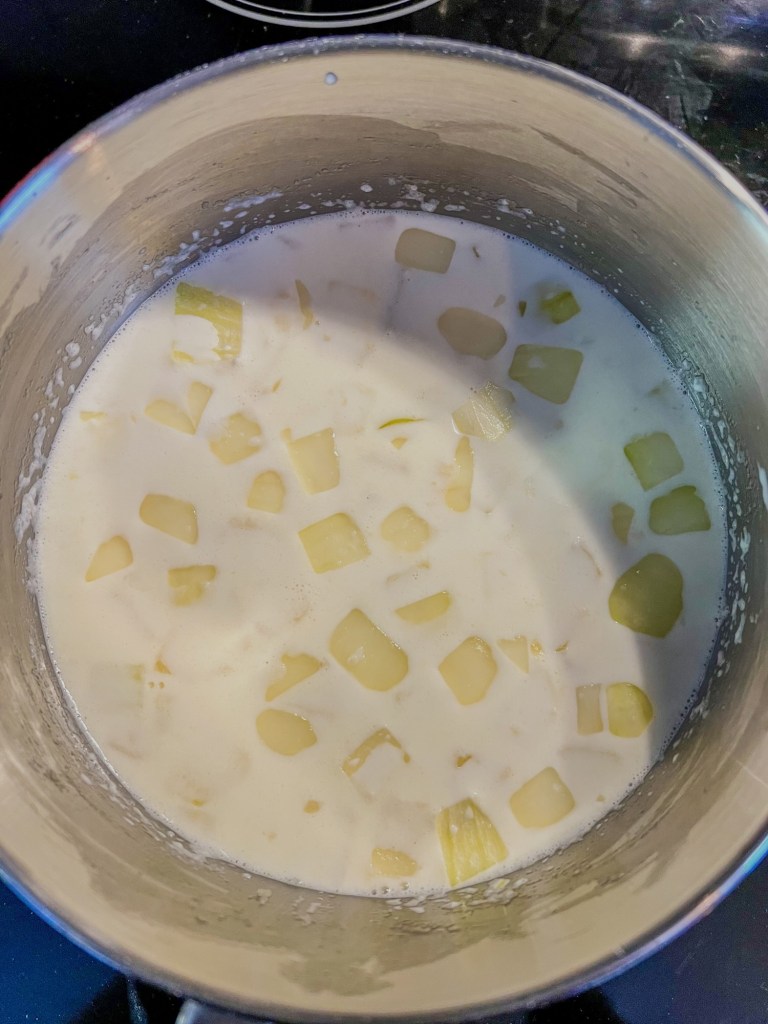 Cheese sauce being made in a saucepan