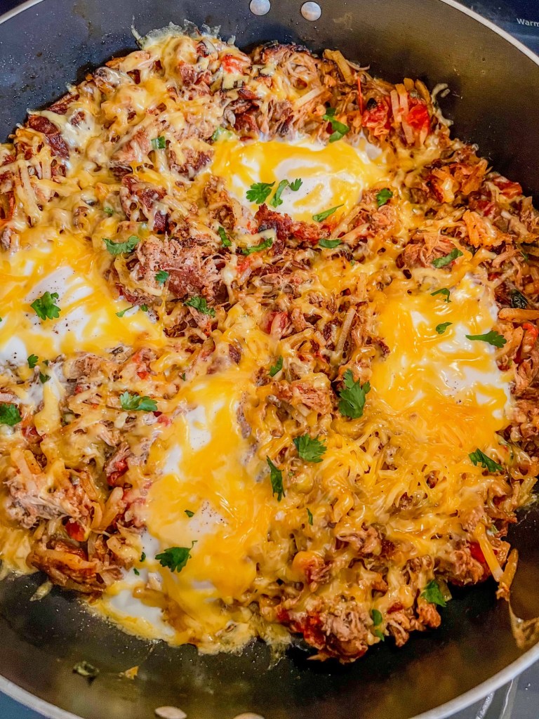Pulled pork breakfast skillet in a large skillet on the stove