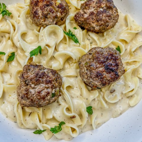 Swedish Meatballs in a white bowl on a wooden counter
