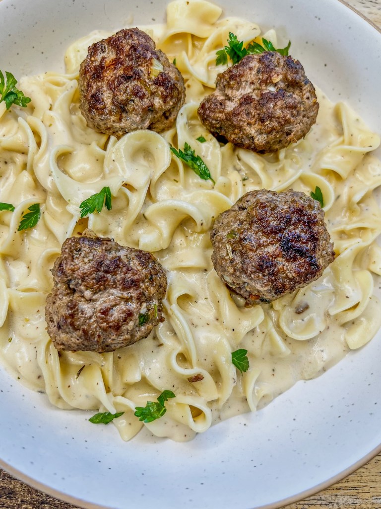Swedish Meatballs in a white bowl on a wooden counter