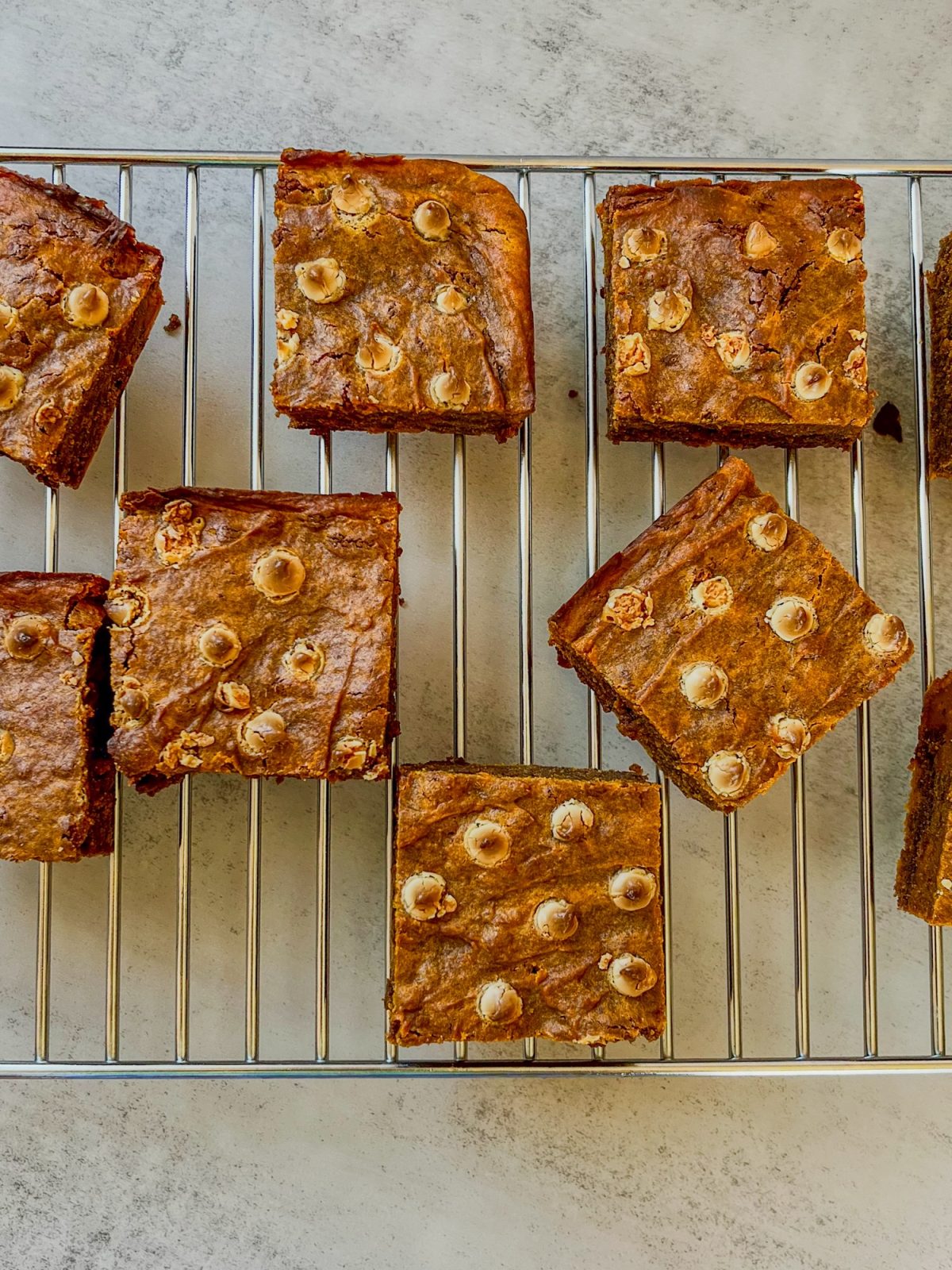 Pumpkin brownies on a cooling rack on a countertop